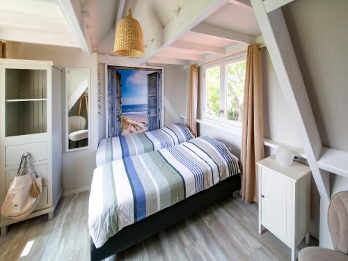 a bedroom with a bed and a window at Beautiful Apartment in Callantsoog near Beach in Callantsoog