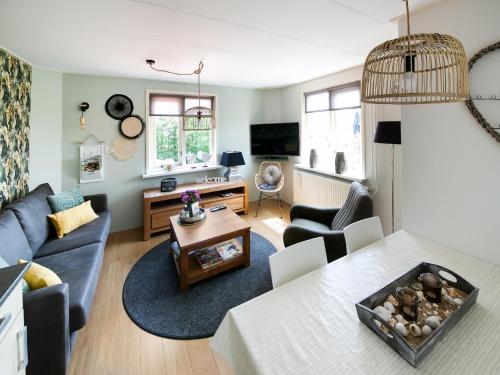 a living room with a couch and a table at Beautiful Apartment in Callantsoog near Beach in Callantsoog
