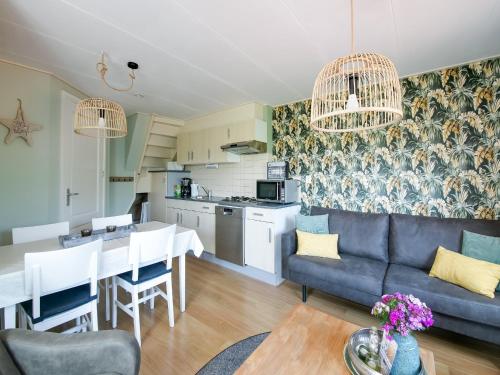 a living room with a couch and a table at Beautiful Apartment in Callantsoog near Beach in Callantsoog