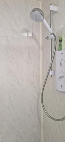 a shower with a shower head in a bathroom at Loft Style-1Br-WalkinShower-WiFi-Central Cork in Cork