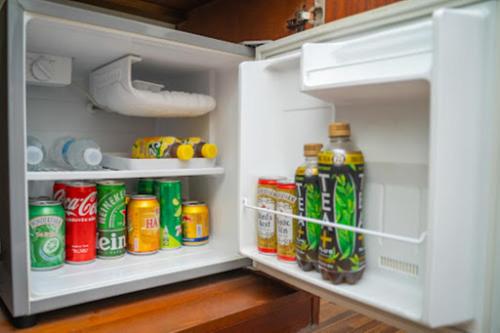 an open refrigerator filled with lots of drinks at Sunny Hotel in Hanoi