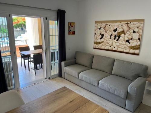 a living room with a couch and a table at Costa Adeje Fañabé Beach Apartment in Adeje