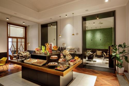 a kitchen with a table with food on it at Hotel Nord Nuova Roma in Rome