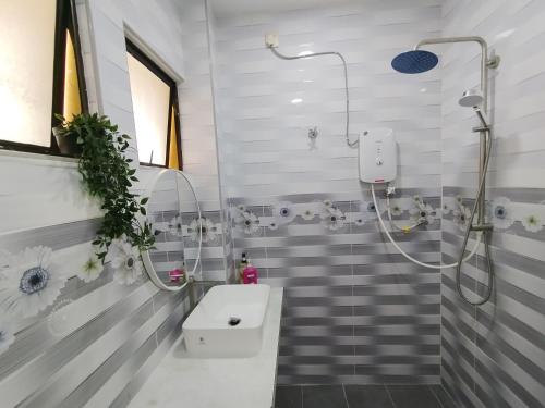 a bathroom with a shower and a sink at Dim Sum Homestay in Ipoh