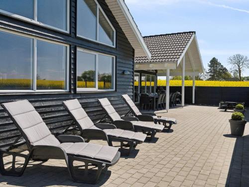 a row of chairs sitting outside of a building at 5 star holiday home in Bogense in Bogense