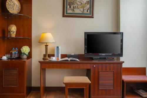a room with a desk with a television on it at Sunny Hotel in Hanoi