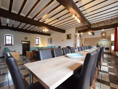 a conference room with a long wooden table and chairs at Luxury Holiday Home in Melreux-Hotton with Sauna in Melreux