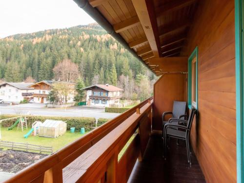a balcony with a view of a yard at Lovely Apartment with Sauna, Ski Storage, Pool, Terrace in Wald im Pinzgau