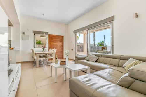 a living room with a couch and a table at Casa Imjo Groundfloor private pool in Orihuela Costa