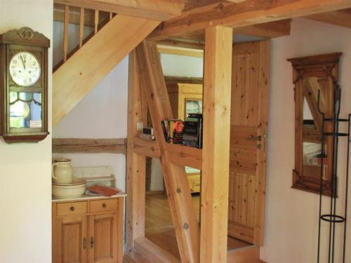 a ladder leading up to a kitchen with a clock at Chic Apartment in Thuringia with Sauna in Hamma