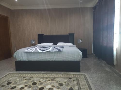 a bedroom with a large bed with white sheets at Marina Apartments in Lagos