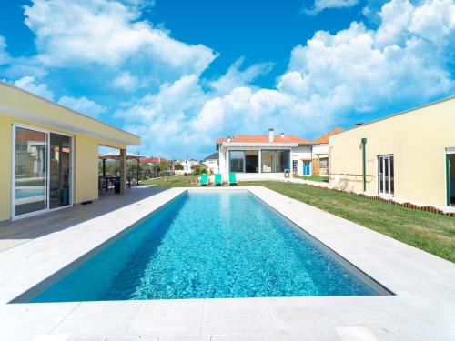 a swimming pool in the backyard of a house at Rural holiday home in Netos-Almagreira with shared pool in Lagares