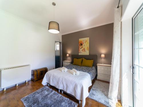 a bedroom with a bed with two pillows on it at Rural holiday home in Netos-Almagreira with shared pool in Lagares