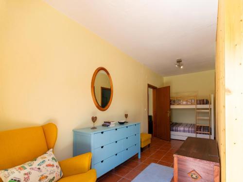 a living room with a blue dresser and a mirror at Rural holiday home in Netos-Almagreira with shared pool in Lagares