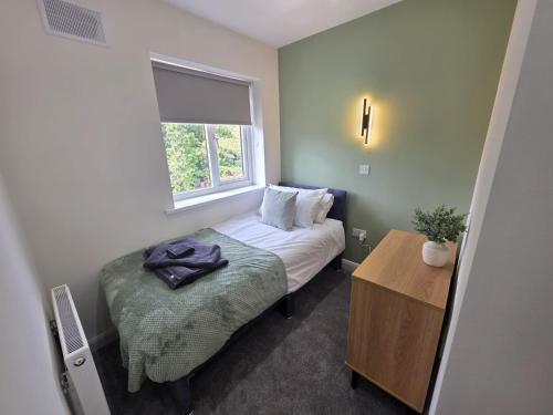 a small bedroom with a bed and a window at House - Sleeps 4 - Parking - Garden - City Centre in Leeds