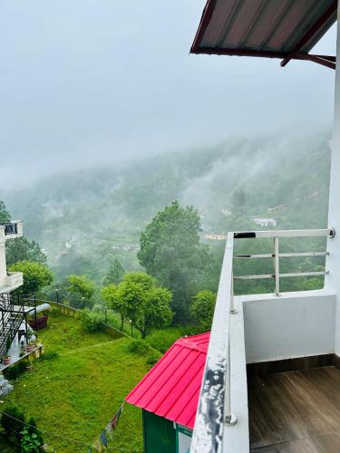 a view from the balcony of a house with a red roof at Green Valley Hotel in Lansdowne