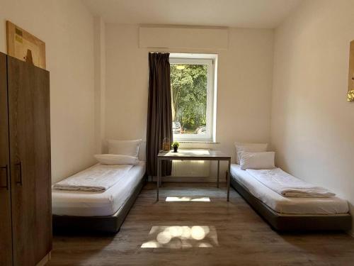 Ένα ή περισσότερα κρεβάτια σε δωμάτιο στο DIM Monteurzimmer Duisburg