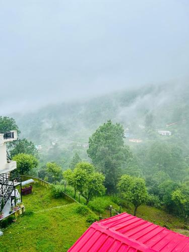 a view of a mountain with a red roof at Green Valley Hotel in Lansdowne
