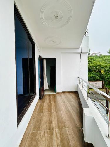 a hallway of a house with a wooden floor at Green Valley Hotel in Lansdowne