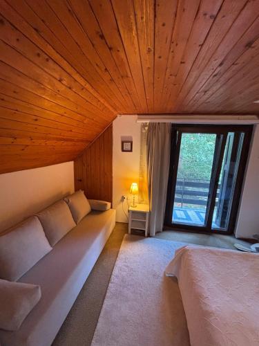 a room with a couch and a large window at Nagyi nyaralója in Balatonszepezd