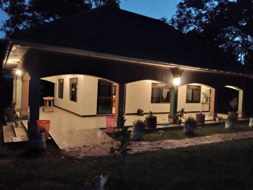 a small house with lights on the front of it at Nguru Farm Cottages in Wakiso
