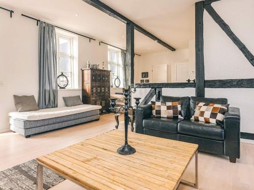 a living room with a couch and a table at 20 person holiday home in Svendborg in Svendborg