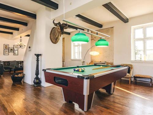 a room with a pool table and green lights at 20 person holiday home in Svendborg in Svendborg