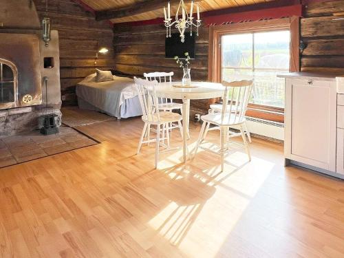 a dining room with a table and chairs and a bed at 4 person holiday home in HOVA-By Traum in Hova