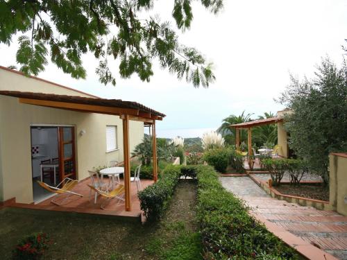 a house with a porch and a patio at Luxurious Holiday Home in Palinuro Italy with Swimming Pool in Centola