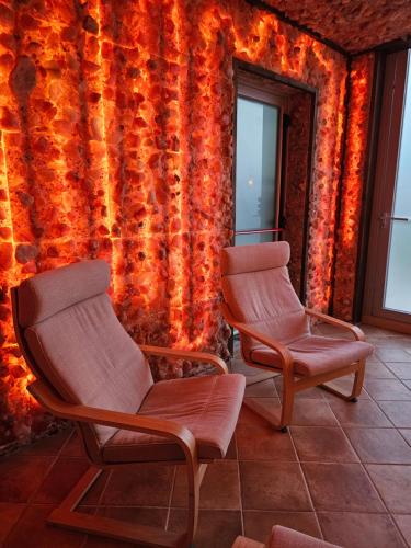 two chairs sitting in a room with a wall at La Magia Lucana in Colobraro
