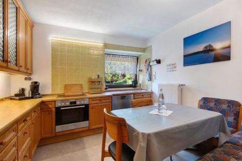 a kitchen with a table and a dining room at Apartment Alte Poststation in Wehr