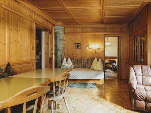 a dining room with a table and a couch at holiday home, Fusch an der Glocknerstraße in Fusch an der Glocknerstraße