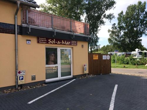 a store front of a building with a sign in the window at Ground-floor apartment with terrace and large garden with lounge area and grill in Mönkebude