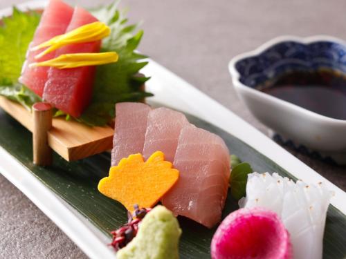 a plate of food with different types of sushi at KAMENOI HOTEL Nachi Katsuura Kumano Kodo in Nachikatsuura