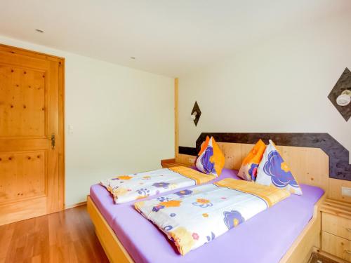 a bed with two pillows on it in a room at Apartment in Silbertal near Ski Lift in Silbertal