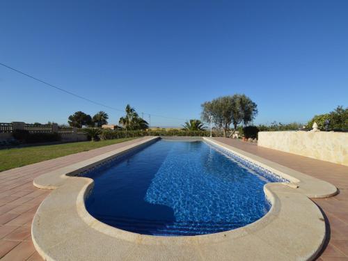 a swimming pool with blue water in a yard at Villa in El Agar with Private Pool and Beaches in Mina Blanca