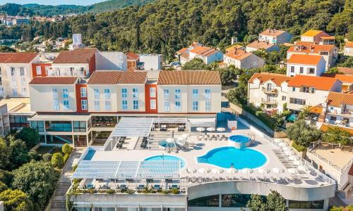 an aerial view of a town with a resort at Marko Polo Maradiso Hotel by Aminess in Korčula