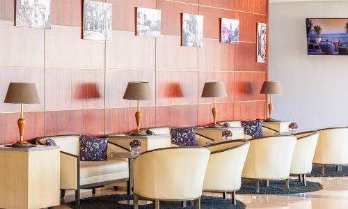 a waiting room with chairs and tables and lamps at Marko Polo Maradiso Hotel by Aminess in Korčula