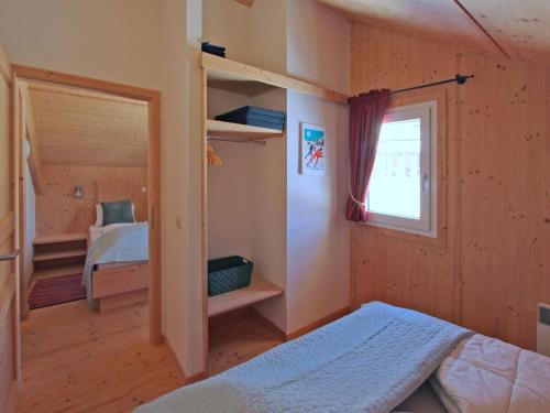 a small bedroom with a bed and a window at Chalet in Hohentauern near Ski Lift in Hohentauern