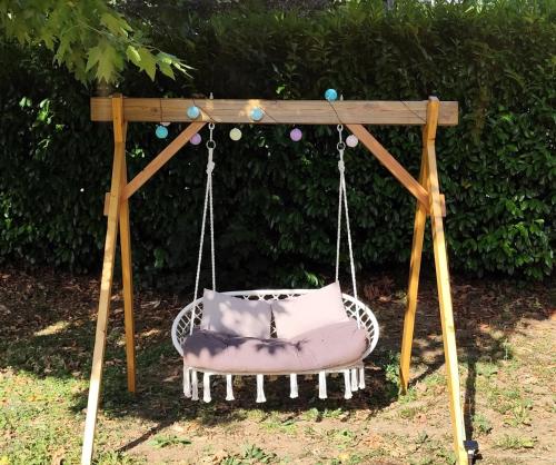 a swing with a pillow on it at Friendly Camping and Lodges in Saint-Pardoux-la-Rivière