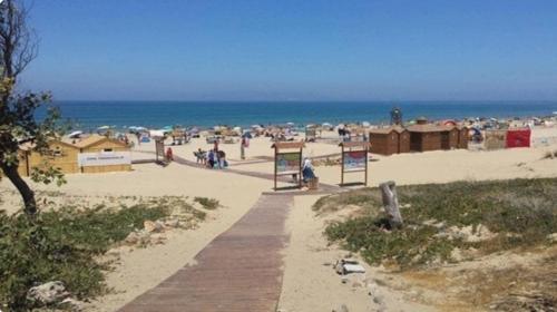 a beach with a bunch of people on the beach at Résidence Tarifa in Mrarech