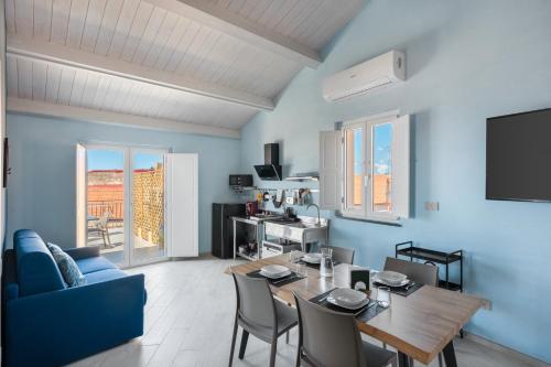 a living room with a table and a blue wall at Palazzo Lucia in Ascea