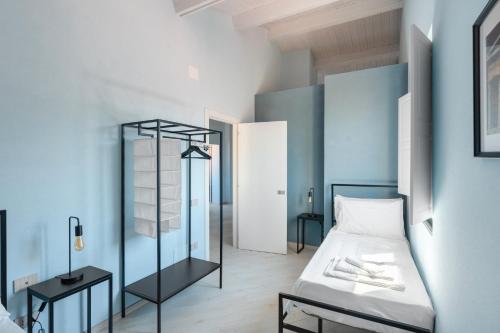a bedroom with a bed and a blue wall at Palazzo Lucia in Ascea