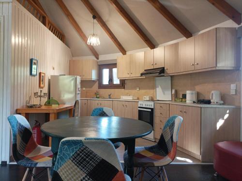 a kitchen with a table and chairs in it at yurt experience in Istiaía