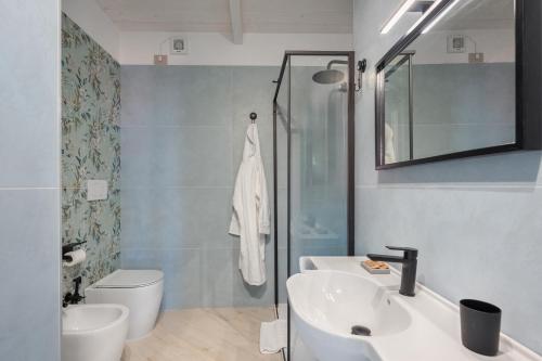 a bathroom with a sink and a toilet and a shower at Palazzo Lucia in Ascea