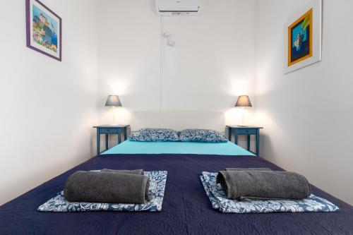 a bedroom with a bed with two pillows on it at Villa with a beautiful sea view near the beach - by Traveler tourist agency Krk ID 2175 in Kornić