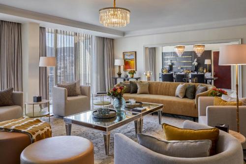 a living room with couches and a table at Taj Cape Town in Cape Town