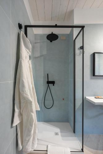 a shower with a glass door and a sink at Palazzo Lucia in Ascea