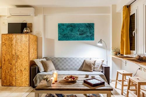 a living room with a couch and a table at Downtown Central Suite with Private Parking in Kalamata