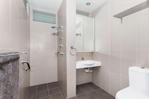 a white bathroom with a sink and a toilet at Dolphin Views in Burrill Lake